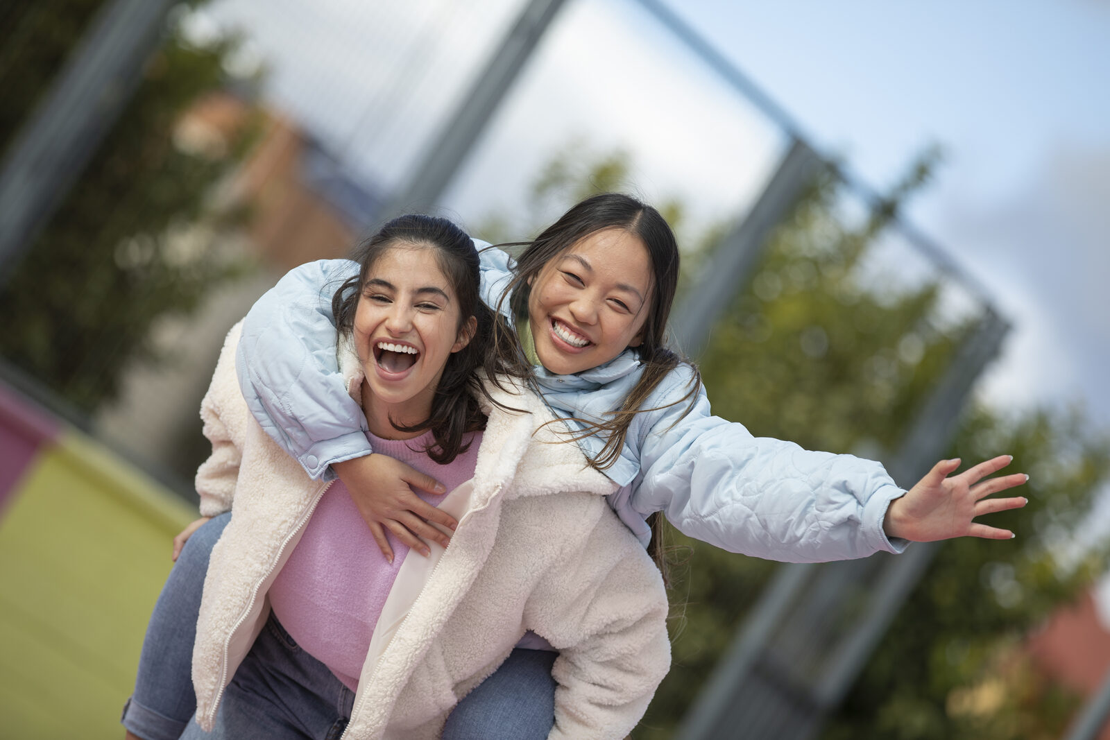 Two young people laughing together outdoors
